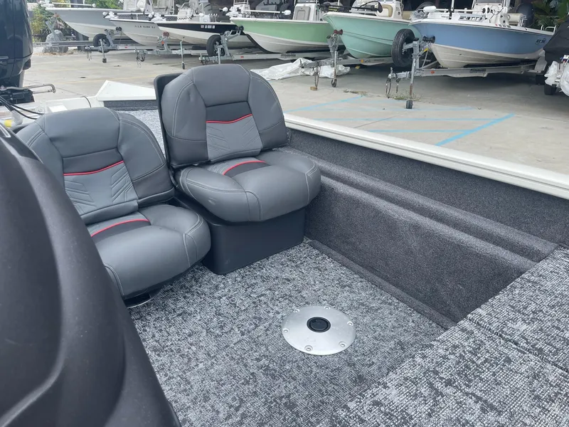Slide: The Image of 2024 Tracker PT175 boat interior with gray seats and carpeted flooring. - 16