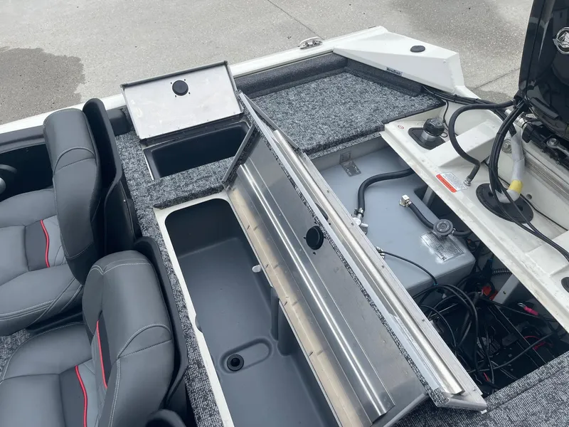 Slide: The Image of 2024 Tracker PT175 boat interior with open storage compartments and seating. - 18