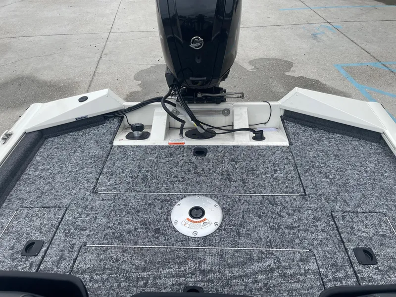 Slide: The Image of 2024 Tracker PT175 boat deck with motor and storage compartments. - 19