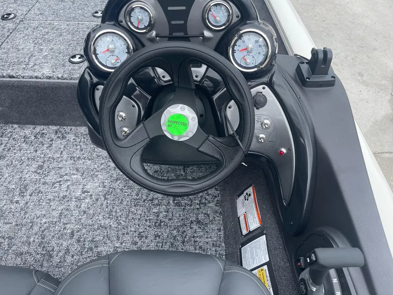 Slide: The Image of 2024 Tracker PT175 boat dashboard with steering wheel and gauges. - 20