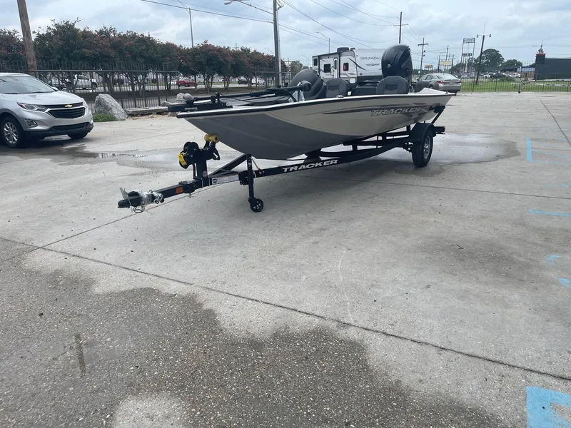 Slide: The Image of 2024 Tracker PT175 boat on a trailer in a parking lot. - 4