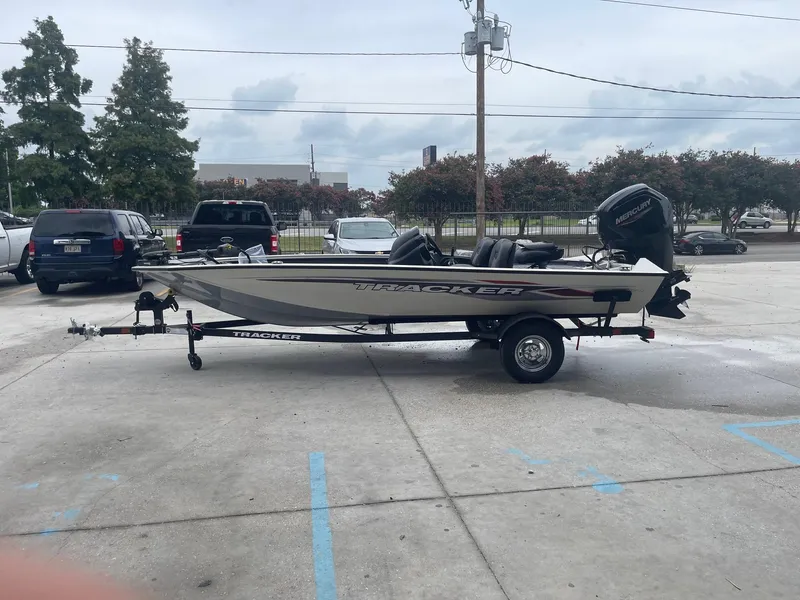 Slide: The Image of 2024 Tracker PT175 boat on a trailer in a parking lot. - 5
