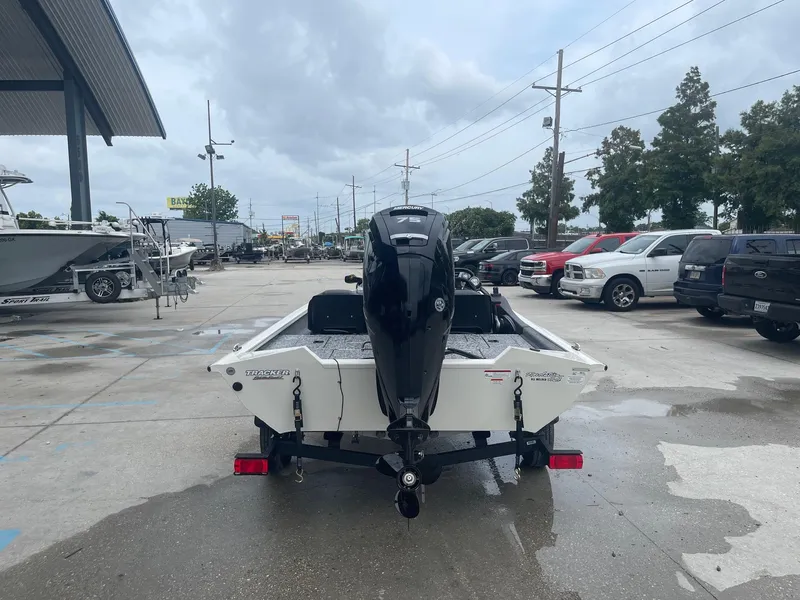 Slide: The Image of 2024 Tracker PT175 boat with outboard motor on trailer in dealership lot. - 7