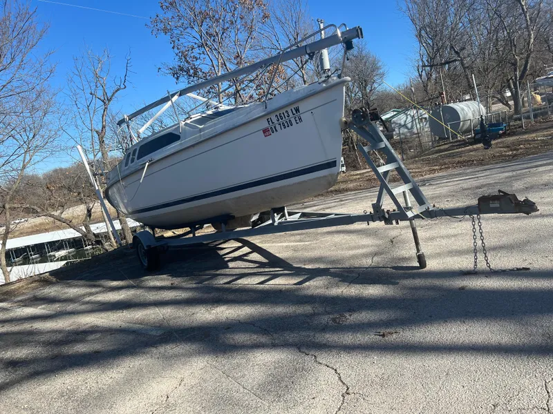 The Image of 2002 Hunter 240 sailboat on trailer in a dry dock area. - 1