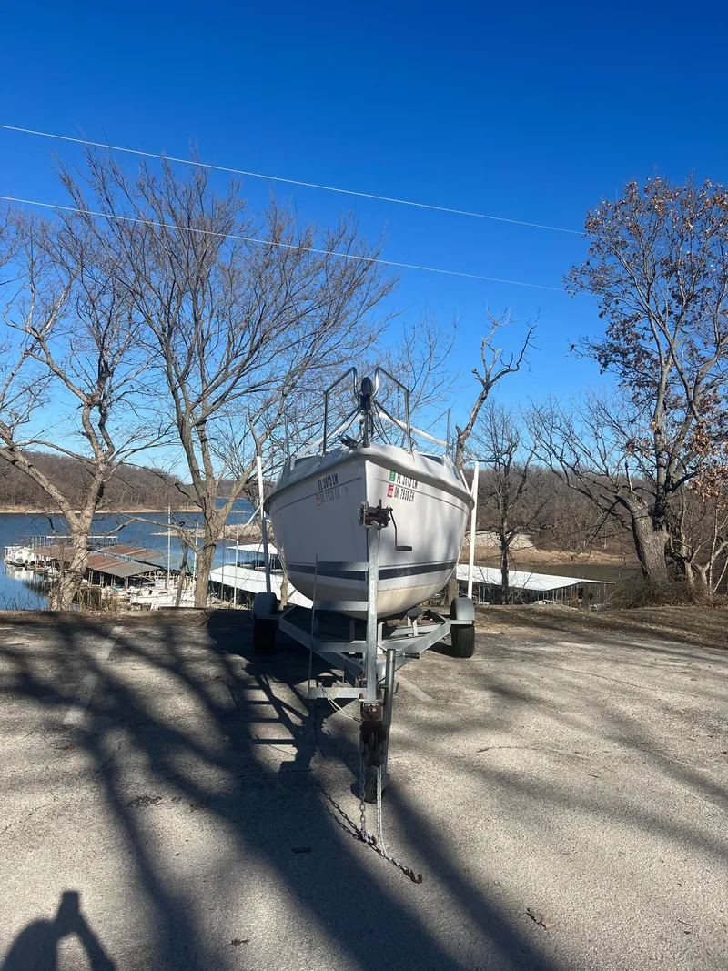 Slide: The Image of 2002 Hunter 240 sailboat on trailer near a lake in winter. - 13
