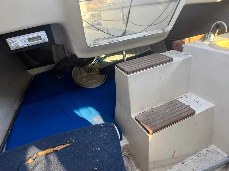 Slide: The Image of Interior of a 2002 Hunter 240 sailboat with steps and seating area. - 5