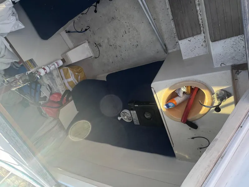 Slide: The Image of Interior of a 2002 Hunter 240 sailboat with seating and storage areas. - 6