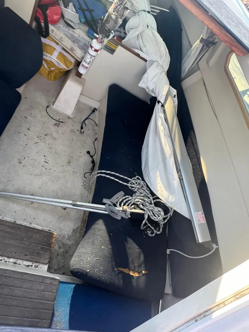 Slide: The Image of Interior of a 2002 Hunter 240 sailboat with equipment and seating. - 7