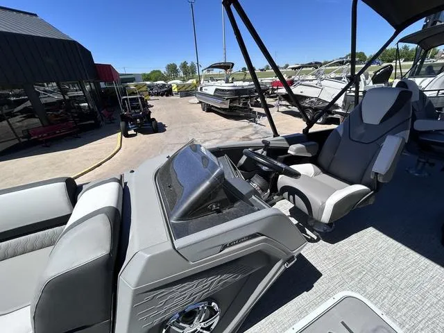 Slide: The Image of 2024 Avalon Catalina Rear Fish 23 FT boat interior with captain's chair and control console. - 10
