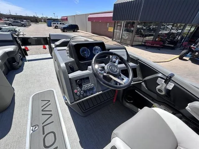 Slide: The Image of 2024 Avalon Catalina Rear Fish 23 FT boat interior with steering console and dashboard. - 16