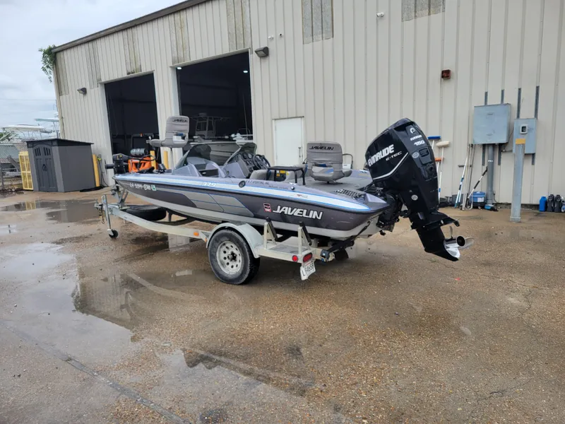 Slide: The Image of 1994 Javelin 379 boat on trailer with Evinrude outboard motor. - 3