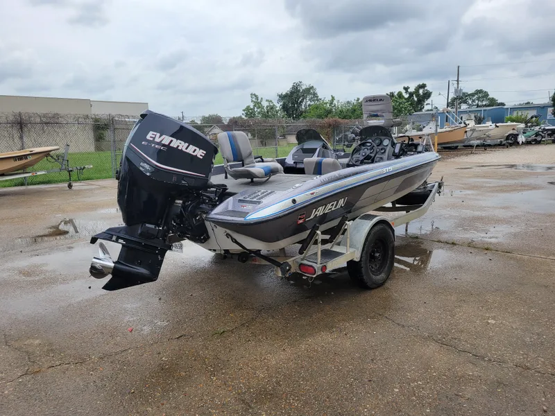 Slide: The Image of 1994 Javelin 379 boat with Evinrude outboard motor on a trailer. - 5