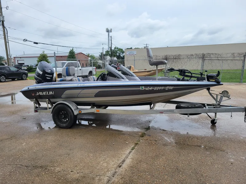 Slide: The Image of 1994 Javelin 379 boat on a trailer in a parking lot. - 6