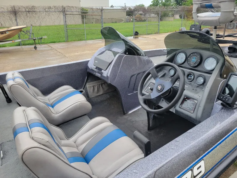 Slide: The Image of 1994 Javelin 379 boat interior with dual seats and dashboard controls. - 7