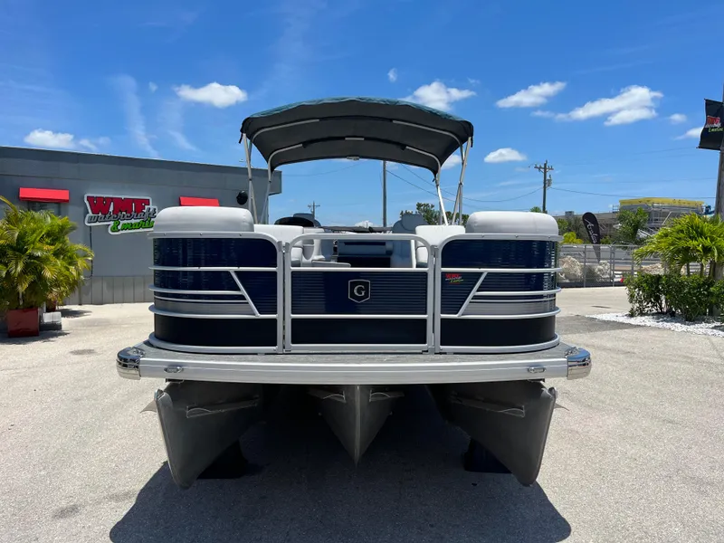 Slide: The Image of 2022 Godfrey SWEETWATER 2486 SFL pontoon boat with canopy in outdoor showroom. - 3