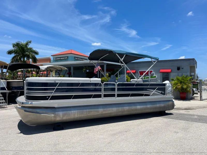 Slide: The Image of 2022 Godfrey SWEETWATER 2486 SFL pontoon boat displayed outdoors on a sunny day. - 4