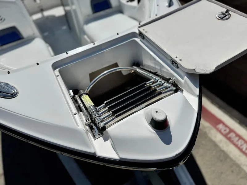 Slide: The Image of Open storage compartment on a 2016 Monterey 244FS boat, showing hydraulic components. - 13
