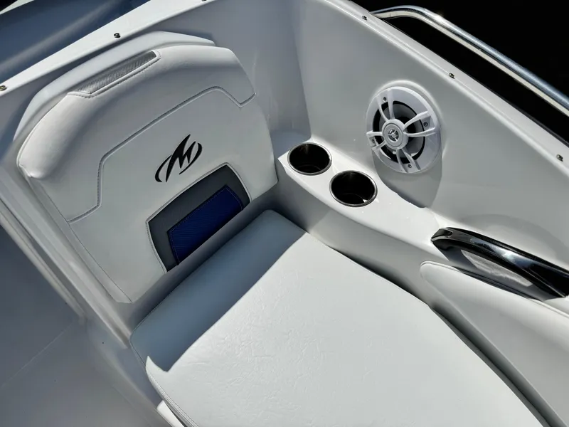 Slide: The Image of 2016 Monterey 244FS boat interior with speaker, cup holders, and cushioned seating. - 17