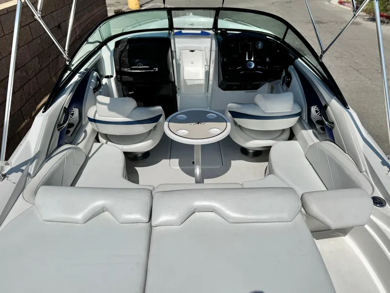 Slide: The Image of 2016 Monterey 244FS boat interior with white seating and central table. - 18