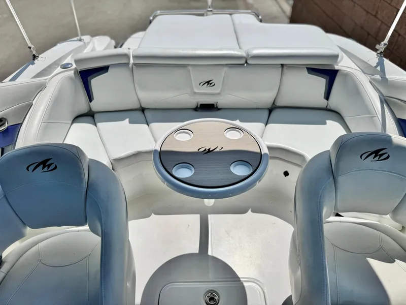 Slide: The Image of 2016 Monterey 244FS boat interior with seating and table, featuring sleek design and comfort. - 20