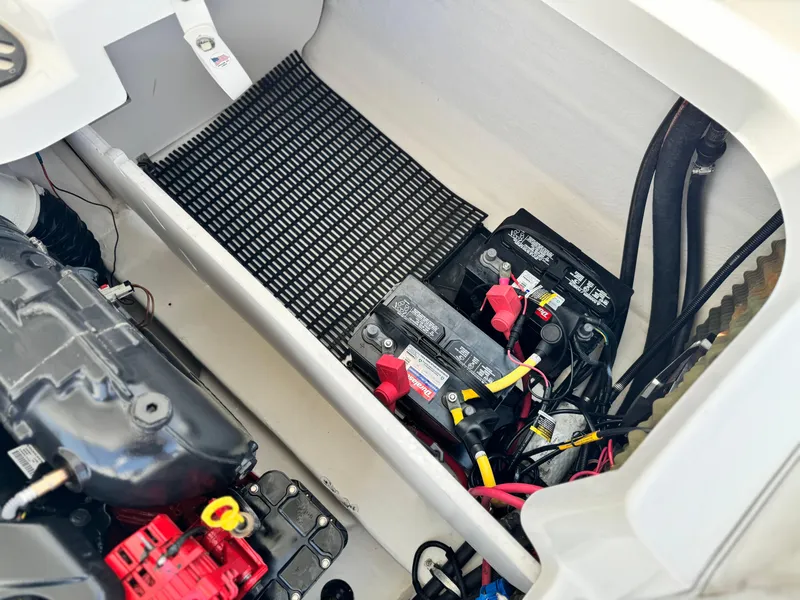 Slide: The Image of 2016 Monterey 244FS boat battery compartment with dual batteries and wiring. - 24