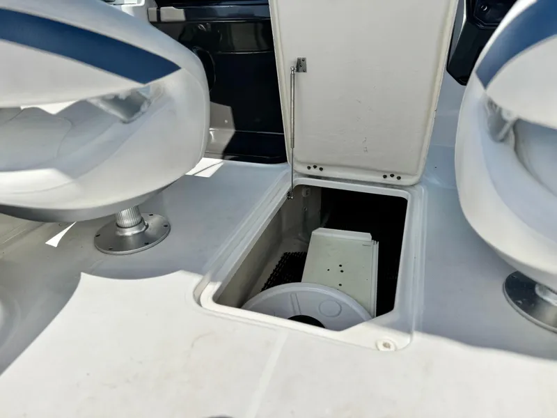 Slide: The Image of Open storage compartment on 2016 Monterey 244FS boat deck, between two seats. - 28