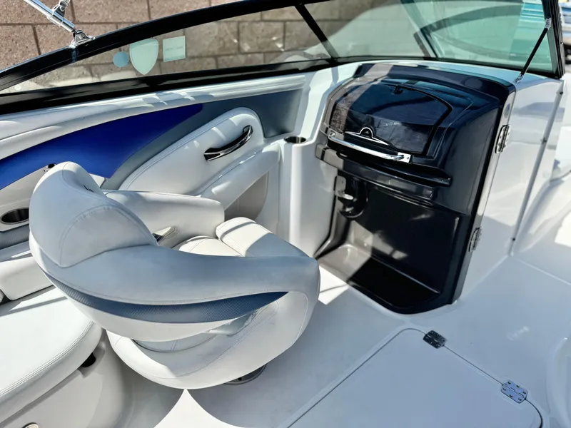 Slide: The Image of 2016 Monterey 244FS boat interior with white seating and sleek dashboard design. - 29