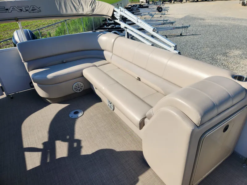 Slide: The Image of 2018 Ranger Reata 220C pontoon boat with beige seating and spacious deck. - 10
