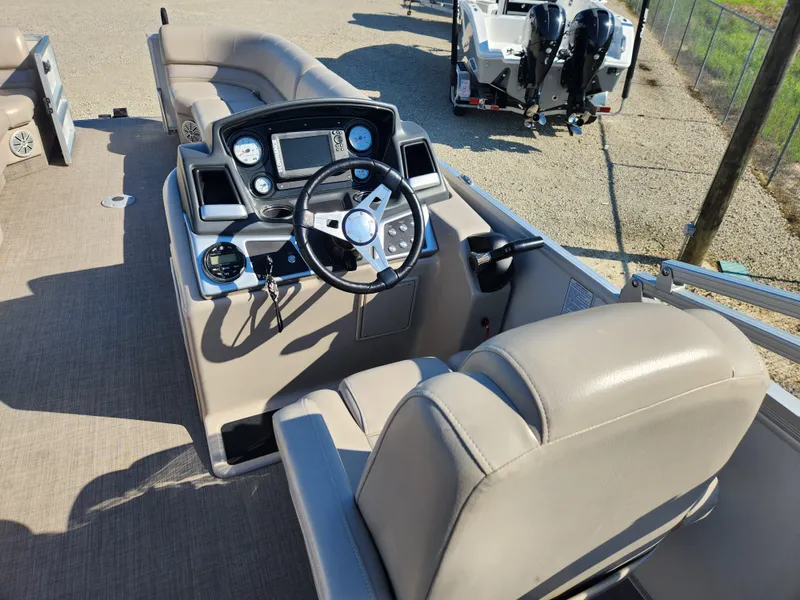 Slide: The Image of 2018 Ranger Reata 220C boat interior with steering console and seating. - 6