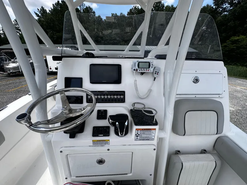 Slide: The Image of 2022 Sea Fox 249 Avenger boat console with steering wheel and navigation equipment. - 12