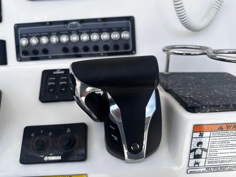 Slide: The Image of Close-up of the control panel and throttle of a 2022 Sea Fox 249 Avenger boat. - 17