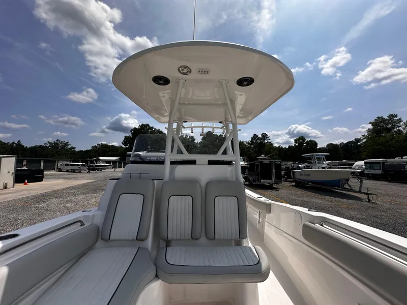 Slide: The Image of 2022 Sea Fox 249 Avenger boat with seating and T-top under a sunny sky. - 20
