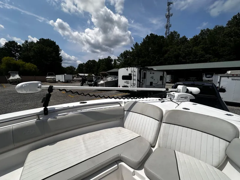 Slide: The Image of 2022 Sea Fox 249 Avenger boat with cushioned seating and trolling motor. - 21