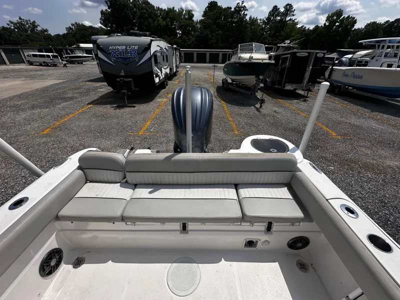 Slide: The Image of 2022 Sea Fox 249 Avenger boat interior with rear seating, parked in a marina. - 22