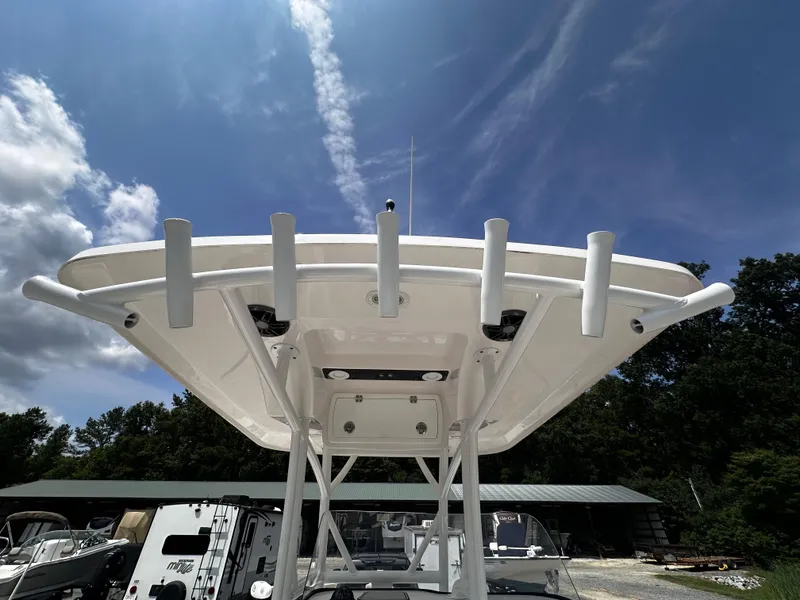 Slide: The Image of 2022 Sea Fox 249 Avenger boat with T-top and rod holders under a clear sky. - 23