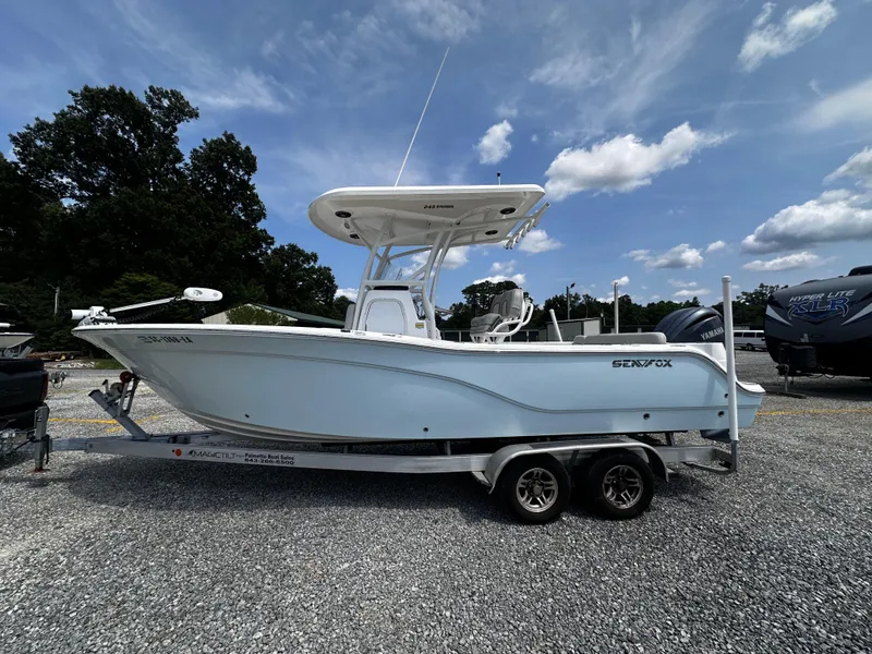 Slide: The Image of 2022 Sea Fox 249 Avenger boat on a trailer under a blue sky. - 7