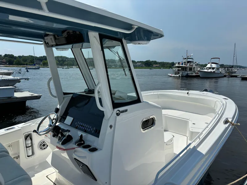 Slide: The Image of 2023 Edgewater 285CC boat docked in a marina. - 1