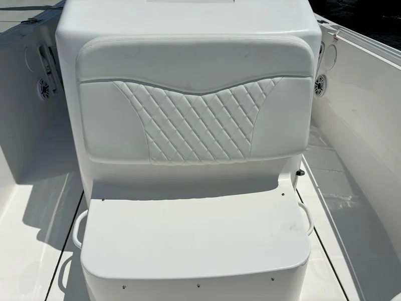 Slide: The Image of 2023 Edgewater 285CC boat seat with white upholstery and diamond stitching. - 7