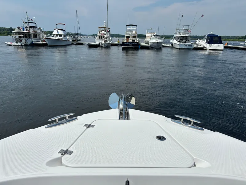 Slide: The Image of Bow view of 2023 Edgewater 285CC boat docked at a marina. - 9