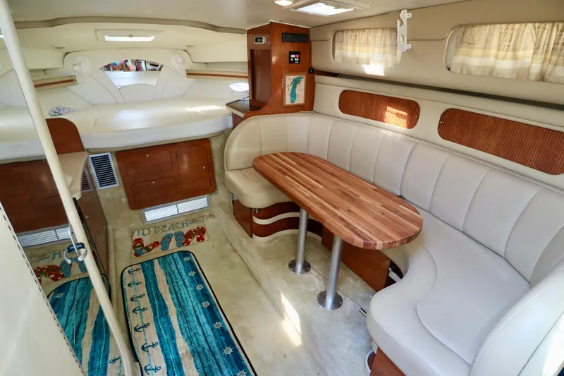Slide: The Image of Interior of 2002 Rinker 342 Fiesta Vee with dining area and bed. - 10
