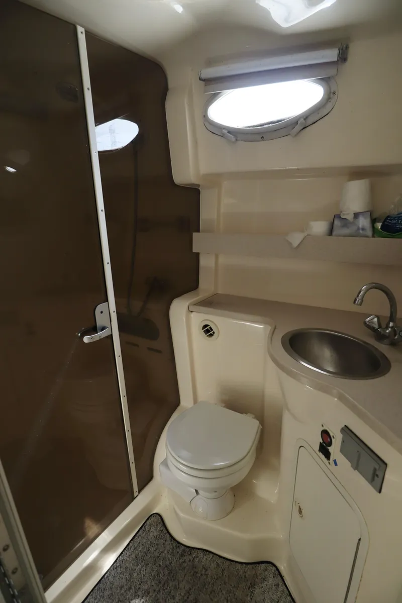 Slide: The Image of 2002 Rinker 342 Fiesta Vee boat bathroom with toilet, sink, and shower. - 11