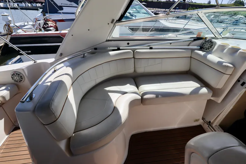 Slide: The Image of 2002 Rinker 342 Fiesta Vee boat interior with white leather seating and wooden flooring. - 14