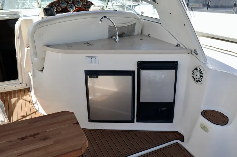 Slide: The Image of 2002 Rinker 342 Fiesta Vee boat interior with kitchenette and wooden flooring. - 17