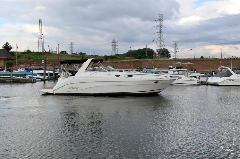 Slide: The Image of 2002 Rinker 342 Fiesta Vee boat docked in a marina under cloudy skies. - 24
