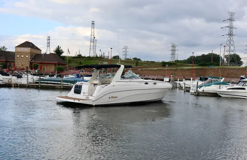 Slide: The Image of 2002 Rinker 342 Fiesta Vee yacht docked in a marina, surrounded by other boats. - 25