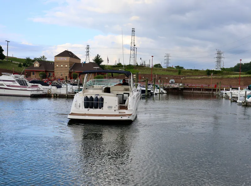 Slide: The Image of 2002 Rinker 342 Fiesta Vee boat docked in a marina with other vessels. - 26
