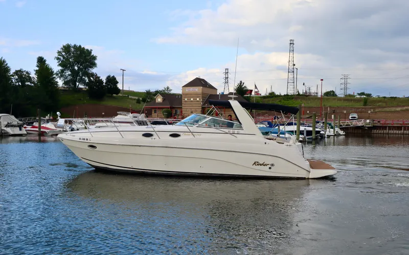 Slide: The Image of 2002 Rinker 342 Fiesta Vee boat docked in a marina. - 27
