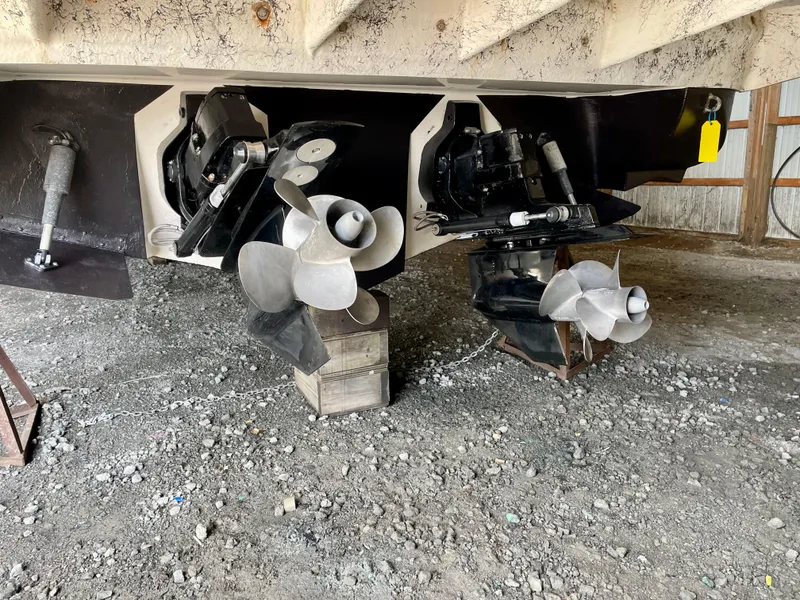 Slide: The Image of 2002 Rinker 342 Fiesta Vee boat propellers and stern drive in a storage area. - 29