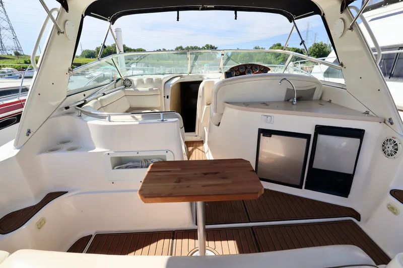 Slide: The Image of Interior of 2002 Rinker 342 Fiesta Vee boat with seating, table, and kitchenette. - 3