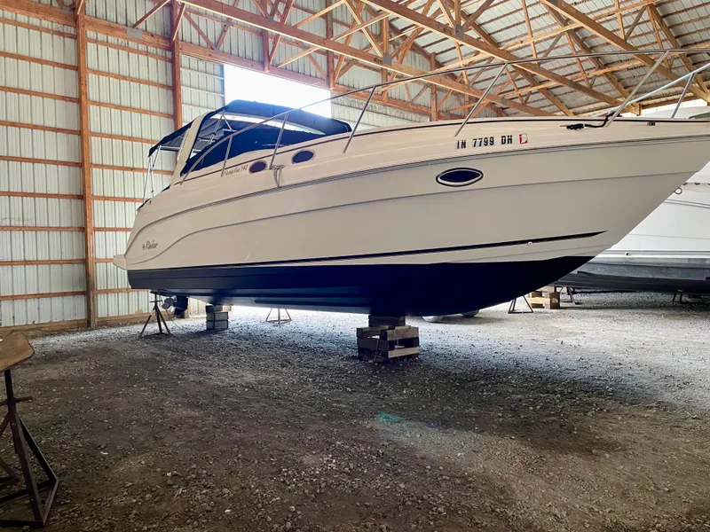 Slide: The Image of 2002 Rinker 342 Fiesta Vee boat stored indoors on blocks. - 32